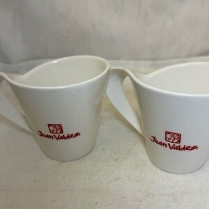 2 modern Juan Valdez coffee mugs.